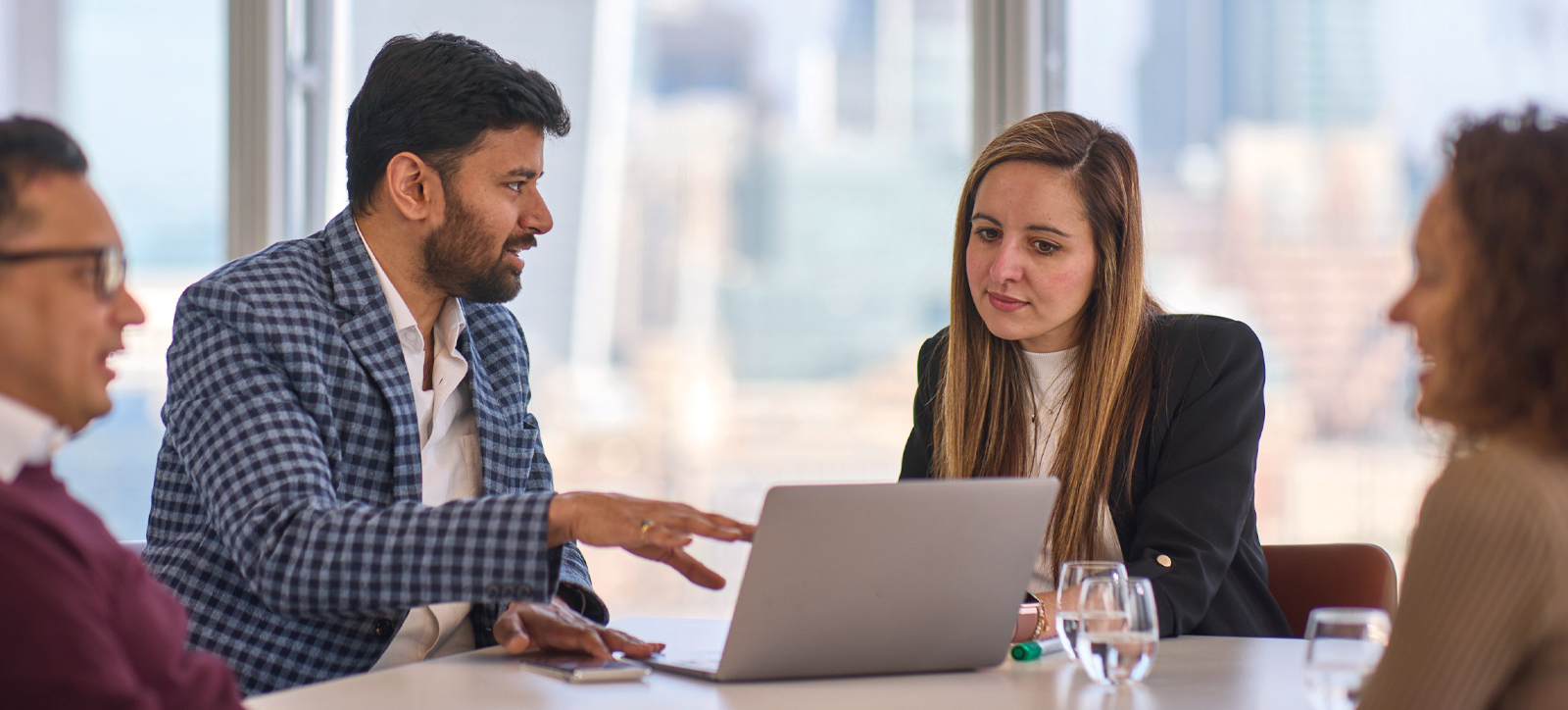 Students talking together around table