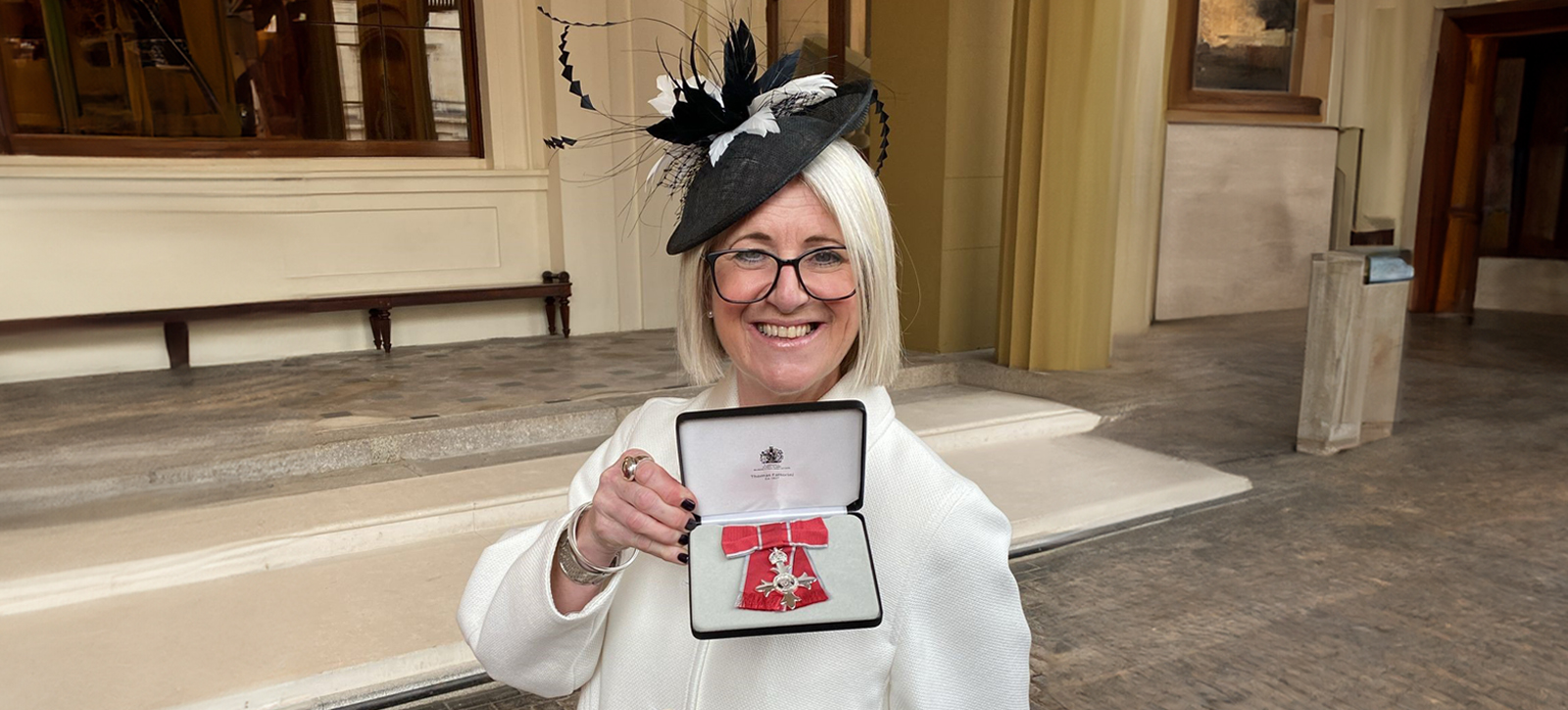 Paula Daes with her MBE at Windsor Castle