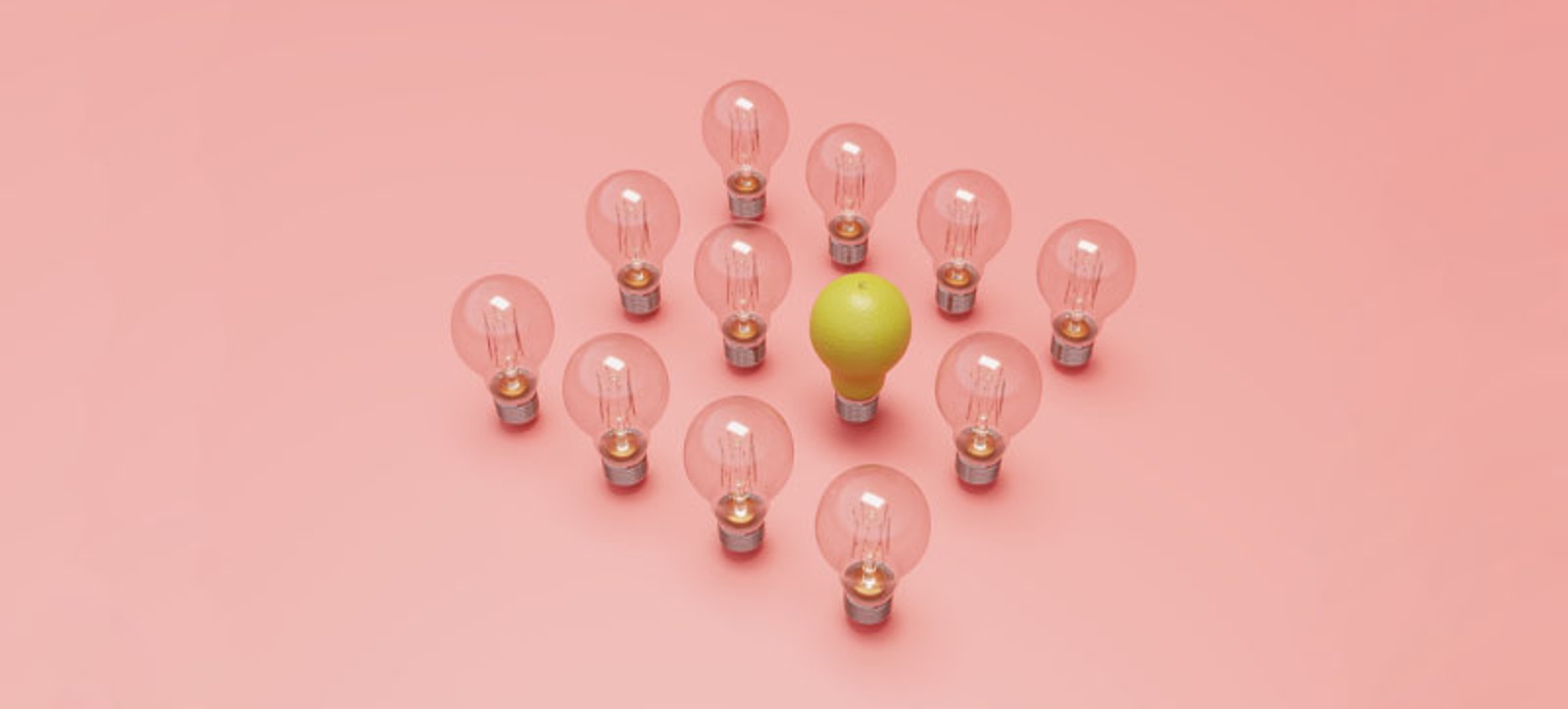 12 lighbulbs arranged in a four by four square formation. 15 are dim and unlit. The final one has been replaced by an upturned pair, creating the illusion of a lit lightbulb inside the group. The bulbs are stood up on a light pink background. 12 lighbulbs arranged in a four by four square formation. 15 are dim and unlit. The final one has been replaced by an upturned pair, creating the illusion of a lit lightbulb inside the group. The bulbs are stood up on a light pink background.