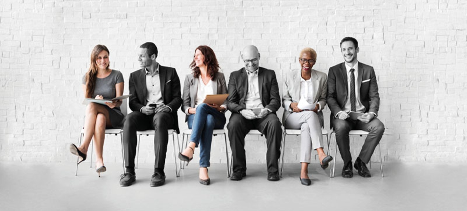 women and men sitting on a bench to represent gender equality