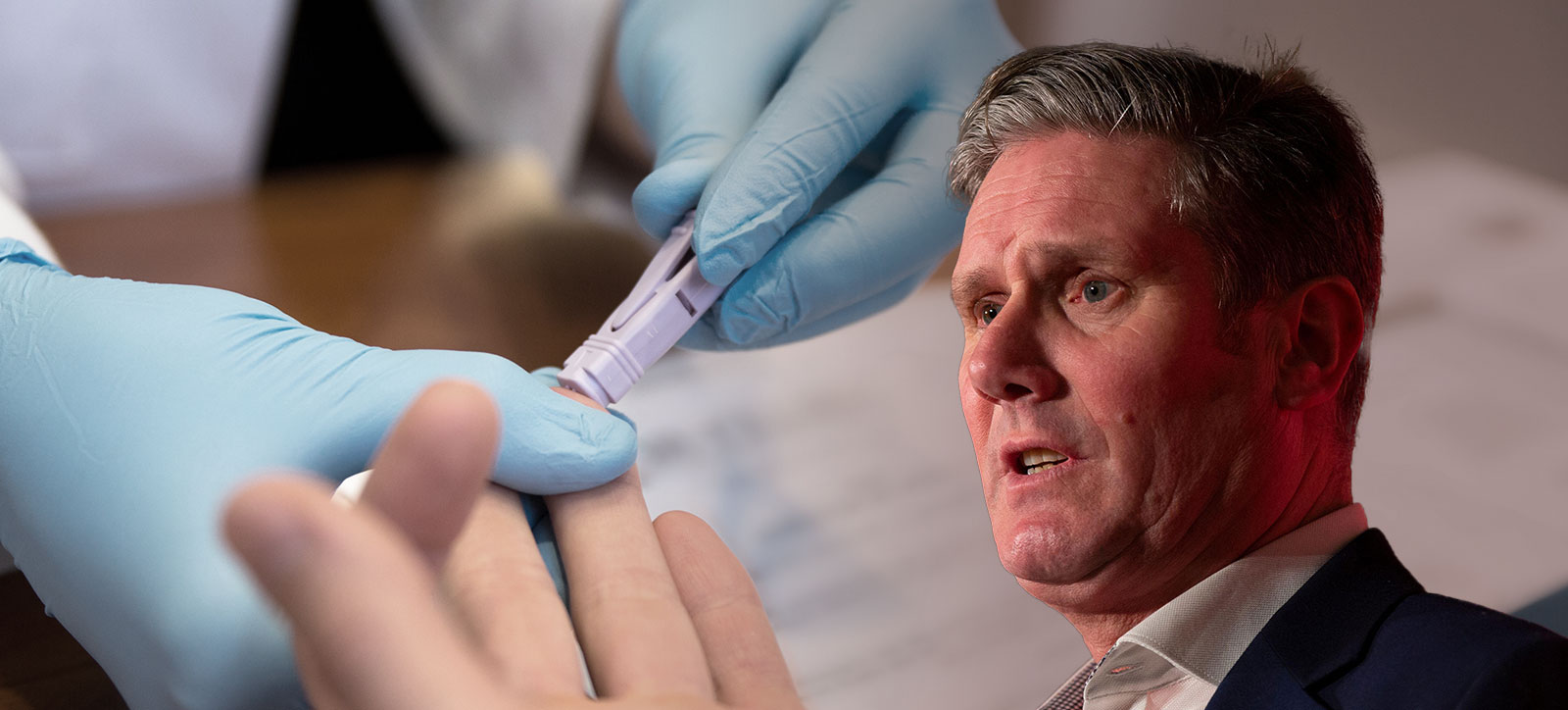 A photograph of UK Prime Minister Keir Starmer set against the backdrop of an HIV testing kit