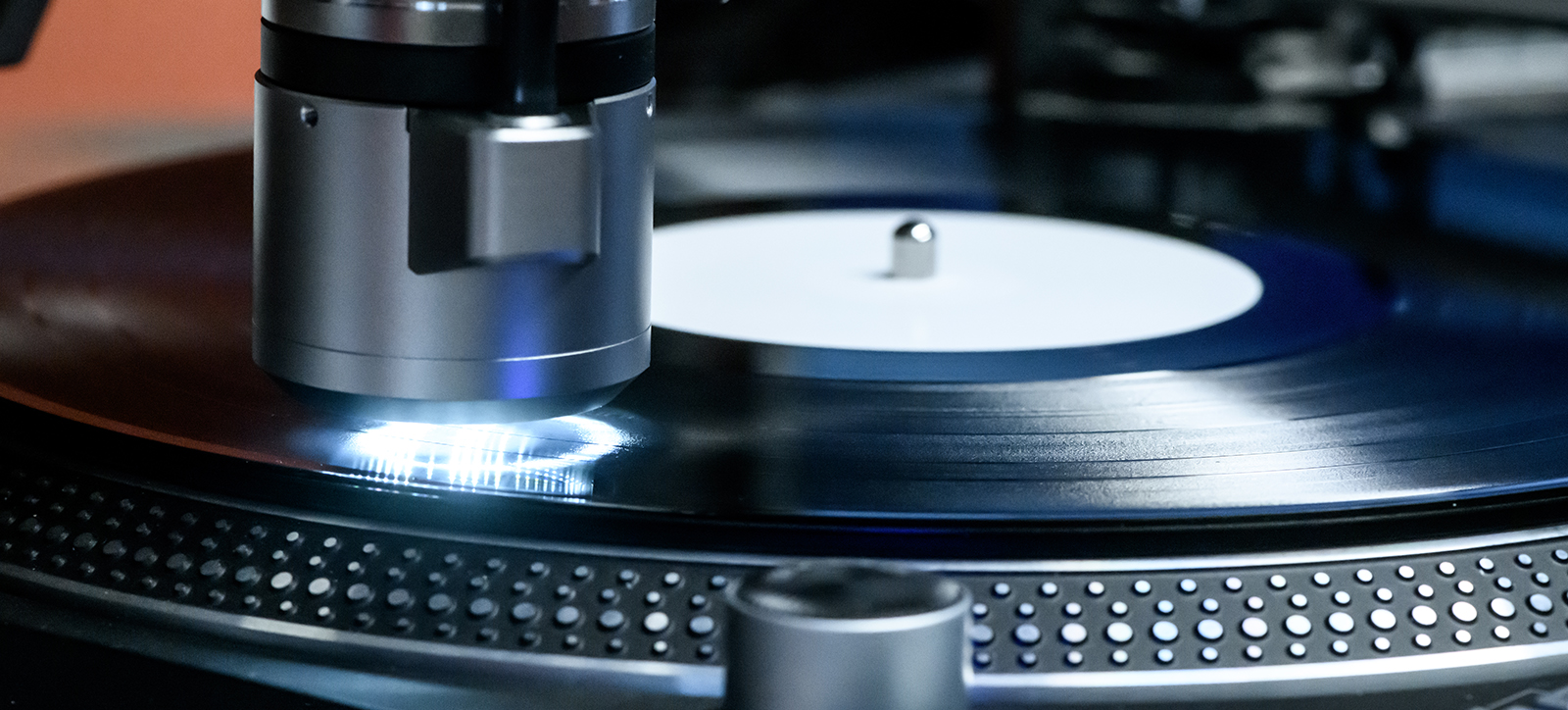 A close-up photograph of a vinyl LP being manufactured.