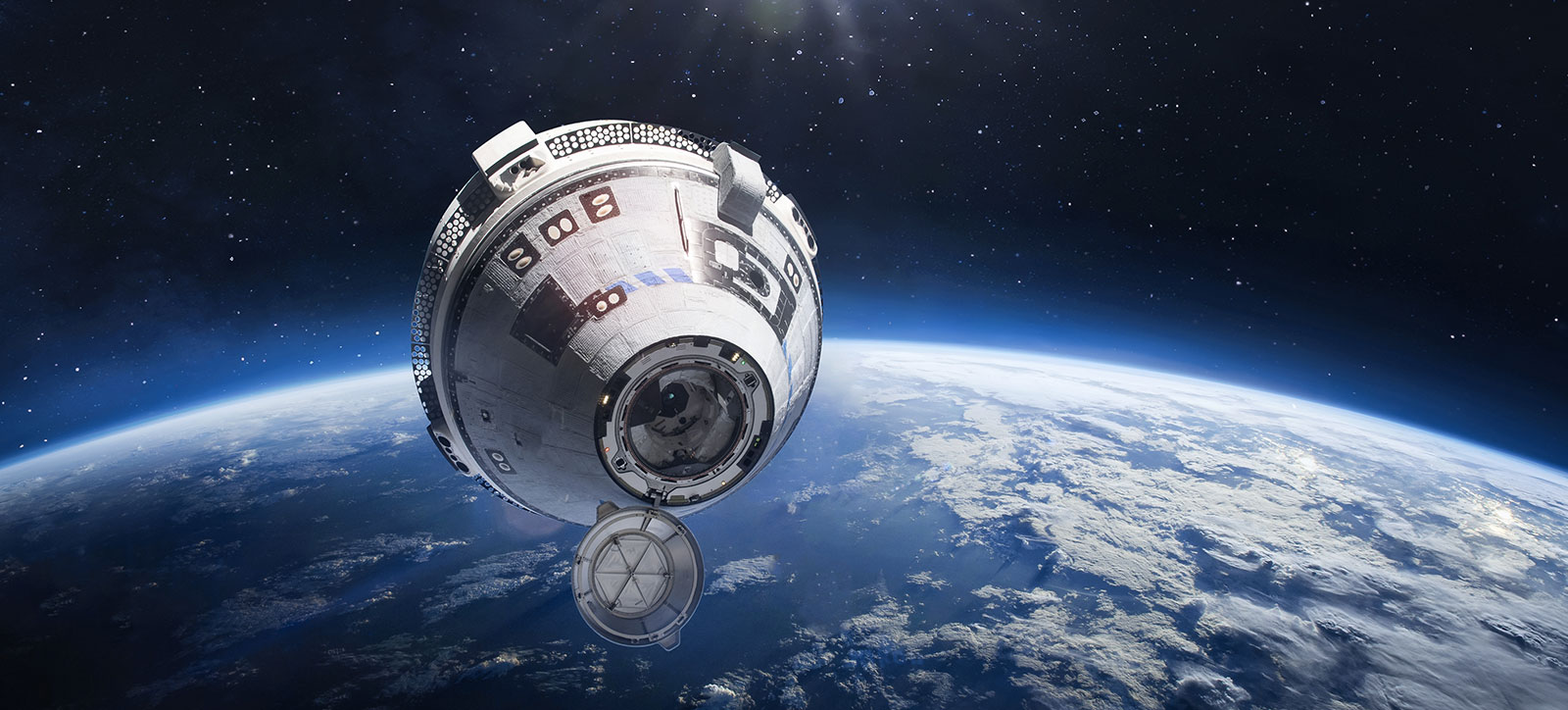 An image of the Boeing Starliner spacecraft high above the Earth.